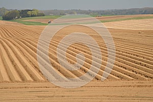 Tractors plough the fields. Belgium.