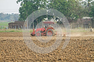 Tractors plow the farm