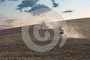 Tractors plow the land for sowing cereal crops on agricultural land