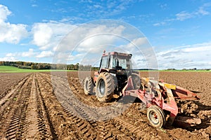 Tractors Plowing Field