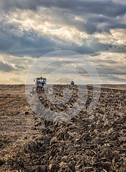 Tractors plowing the soil