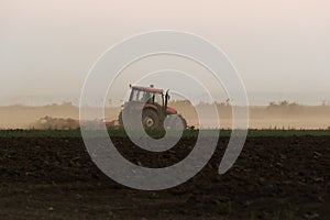 Tractors plowing stubble fields