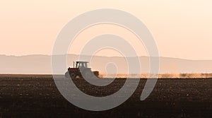 Tractors plowing stubble fields