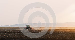 Tractors plowing stubble fields