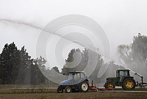 Tractors pump water in the field