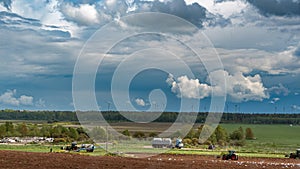 Tractors with sowers on the field in bright sunny spring morning