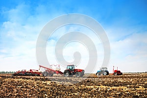 Tractors with tanks in the field. Agricultural machinery and farming.