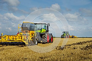 tractors work at field trailed hopper for fertilizers in the field