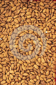 Trade counter with peeled almond nuts. Textured surface. Autumn agricultural fair.