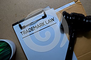 Trademark Law above brown envelope and judges gavel. Justice and Law Concept