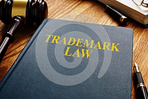 Trademark law and gavel on wooden surface. Copyright concept