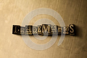 TRADEMARKS - close-up of grungy vintage typeset word on metal backdrop