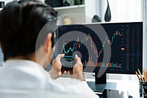 Trader businessman searching on smartphone, analyzing in dynamic stock. Surmise.