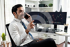 Trader calling to consultant or partner with two stock exchange screen. Surmise.