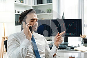 Trader calling to consultant or partner with two stock exchange screen. Surmise.