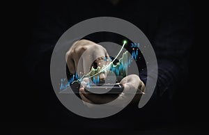 Trader holding smartphone and touching to technical graph chart  for analysis stock market data and speculator investment concept