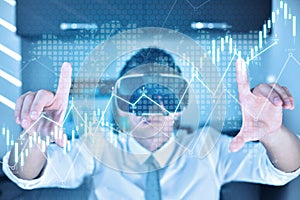 Trader man with VR  glasses controls virtual hologram business statistics and financial report