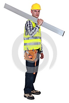 Tradesman carrying a girder photo