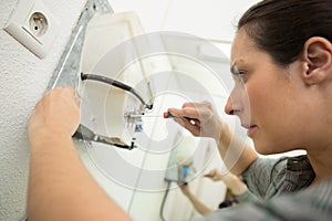 tradesman fixing electrical issue with hand dryer