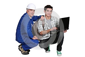 A tradesman helping his apprentice