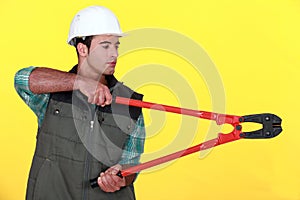 Tradesman holding large clippers