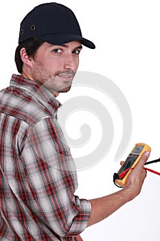 Tradesman holding a multimeter