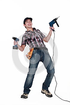 Tradesman holding power tools