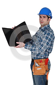 Tradesman looking at laptop