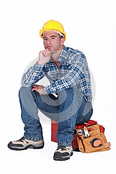 Tradesman sitting on toolchest