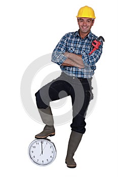 Tradesman stood by a clock