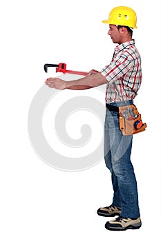 Tradesman using a pipe wrench