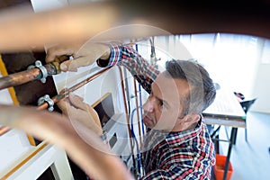 tradesman working on copper pipe installation