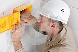 tradesman working in tiled room