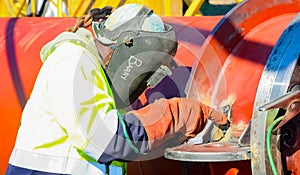 Tradesman working with welding torch