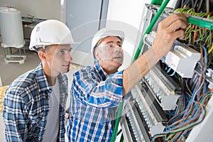 Tradesmen installing distribution board