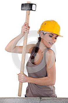 Tradeswoman using a mallet