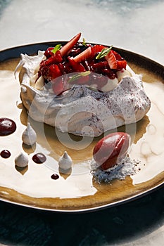 Tradicional Pavlova cake and ice cream served on plate