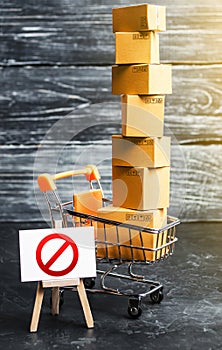 Trading cart with boxes and an easel with a prohibition symbol NO. Internet trade online shopping ban. Restriction on importation photo