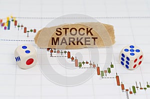 On the trading charts, there are dice and pieces of paper with the inscription - STOCK MARKET