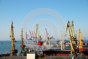 The trading seaport with cranes, cargoes and ship