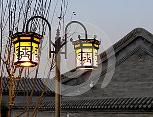 Tradional streetlamps light up a Beijing hutong.