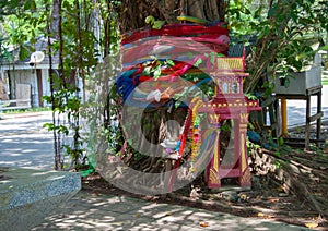 Tradional Thai Spirit house at tree