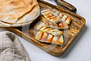 Traditinal Cypriot Halloumi Cheese, on white stone table background