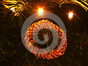 Tradition Christmas ring decoration made from dry straw. Christmas tree with small gentle lights.