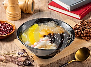 Tradition grass jelly, mango, beans and rice ball served in bowl isolated on table top view of asian food