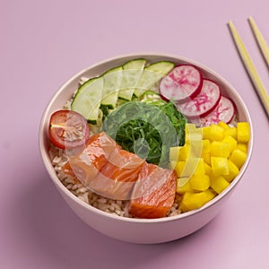 Traditiona Hawaiian red fish poke bowl with rice, radish,cucumber, tomato, and seaweeds. Buddha bowl. Diet food. Flat lay