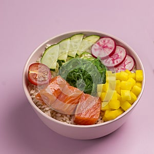 Traditiona Hawaiian red fish poke bowl with rice, radish,cucumber, tomato, and seaweeds. Buddha bowl. Diet food. Flat lay