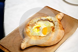 Traditional Adjara khachapuri. In a boat of dough baked cheese,