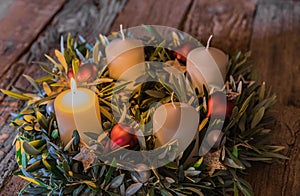 Traditional Christmas wreath with one burning candle