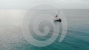 Traditional Africal Sailboat at Zanzibar island Nungwi beach in blue Indian ocean aerial view. Unguja, tanzania